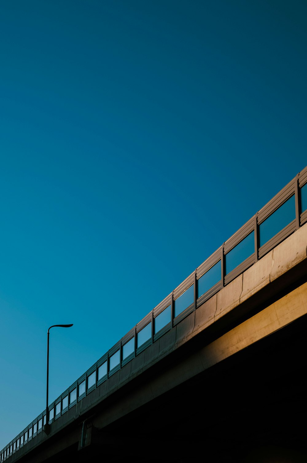 a bridge with a traffic light and a street light