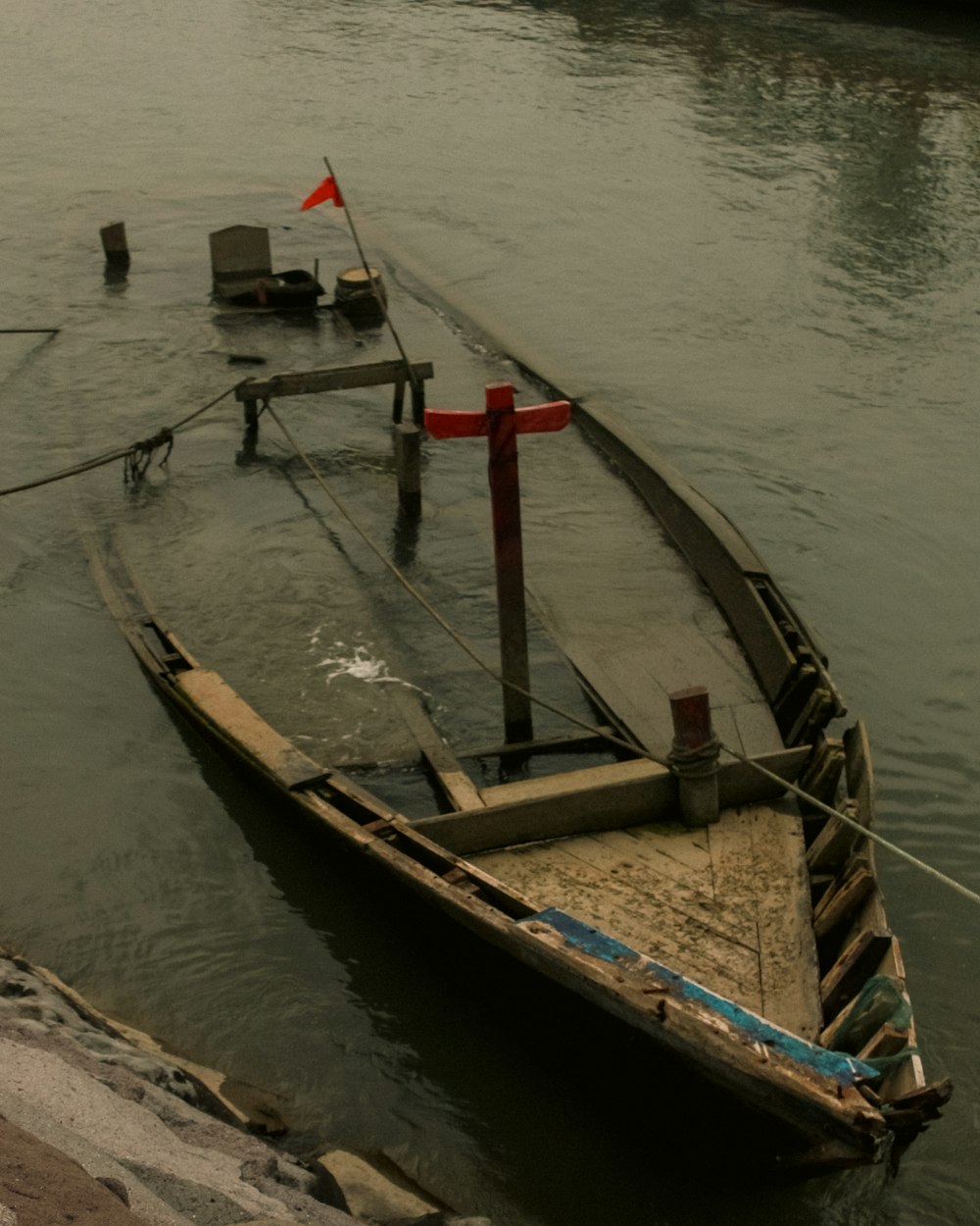 a small boat tied to a dock in a body of water