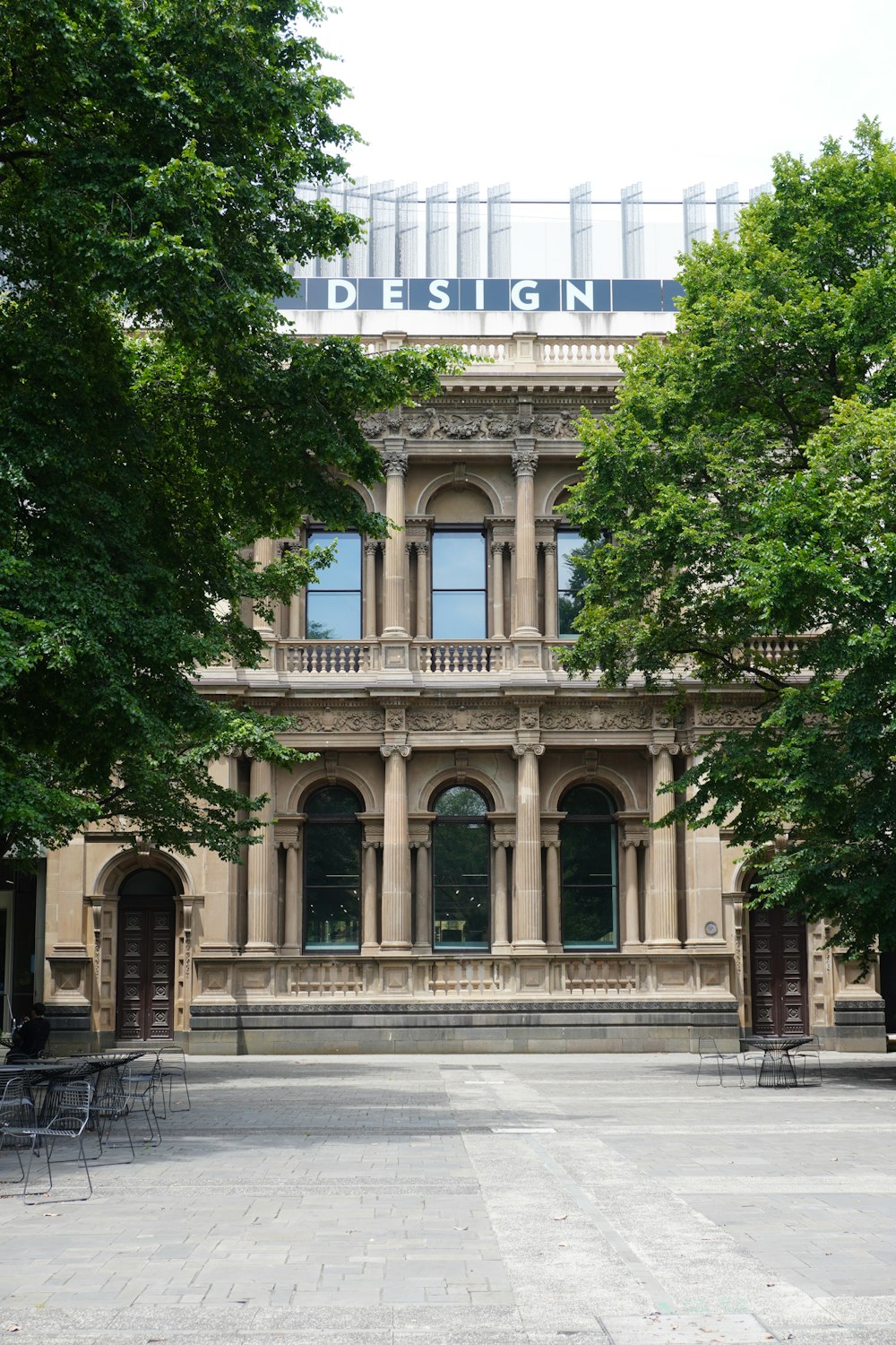 a large building with a lot of trees in front of it