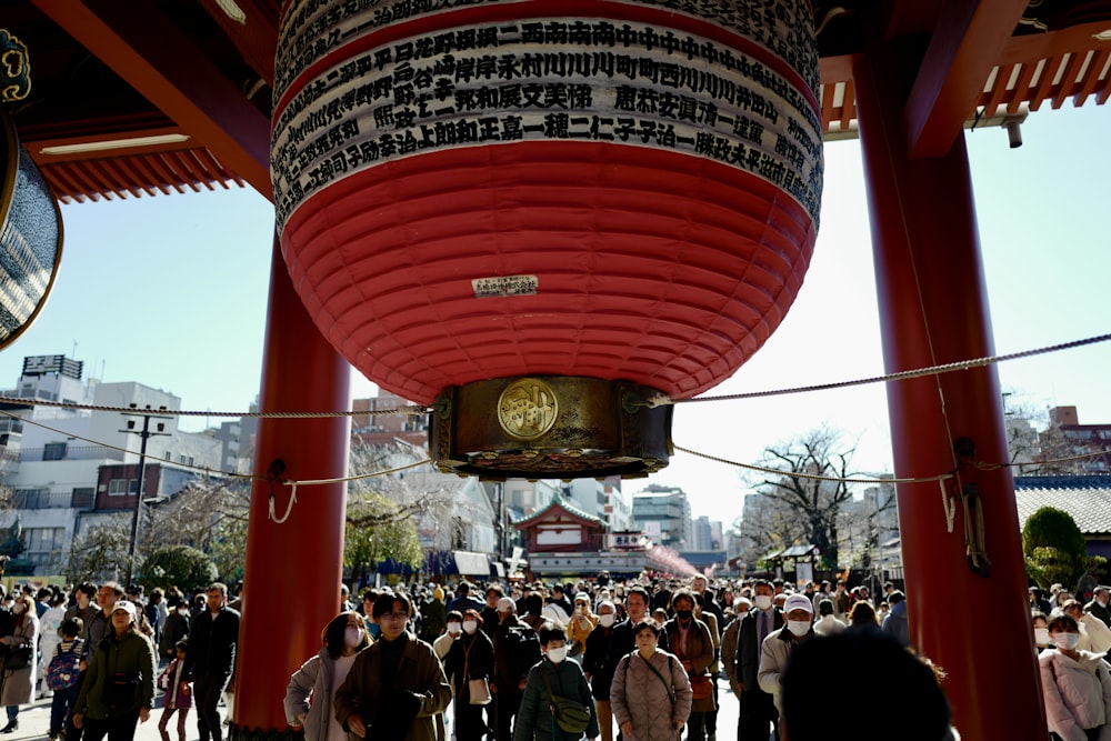 a group of people standing around a red structure