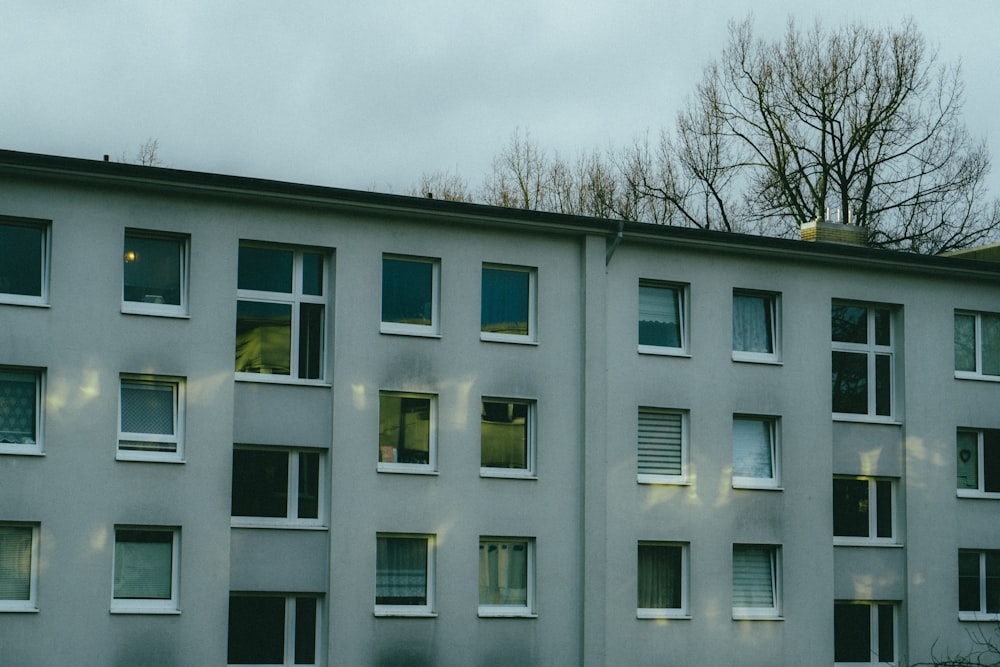 a building with many windows and a clock on the side of it