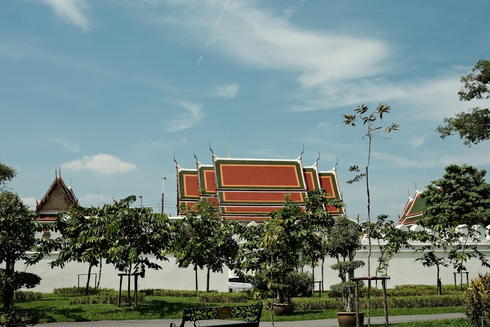 a park with a bench and a building in the background