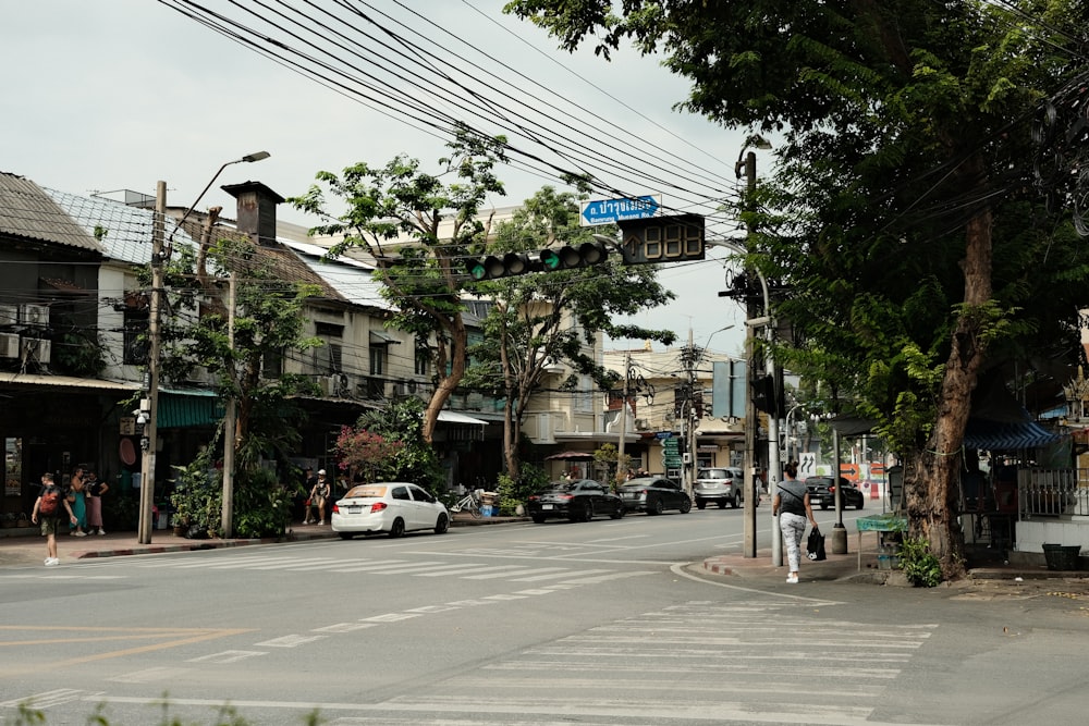 a city street with cars parked on the side of the road