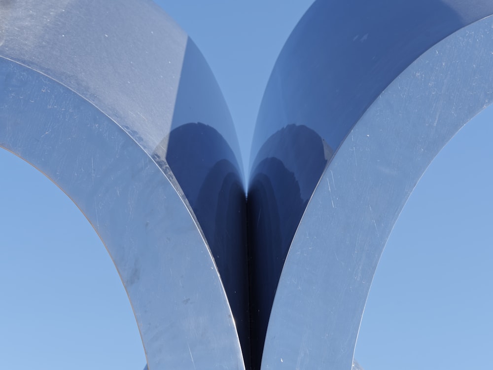 a large metal sculpture with two curved sections