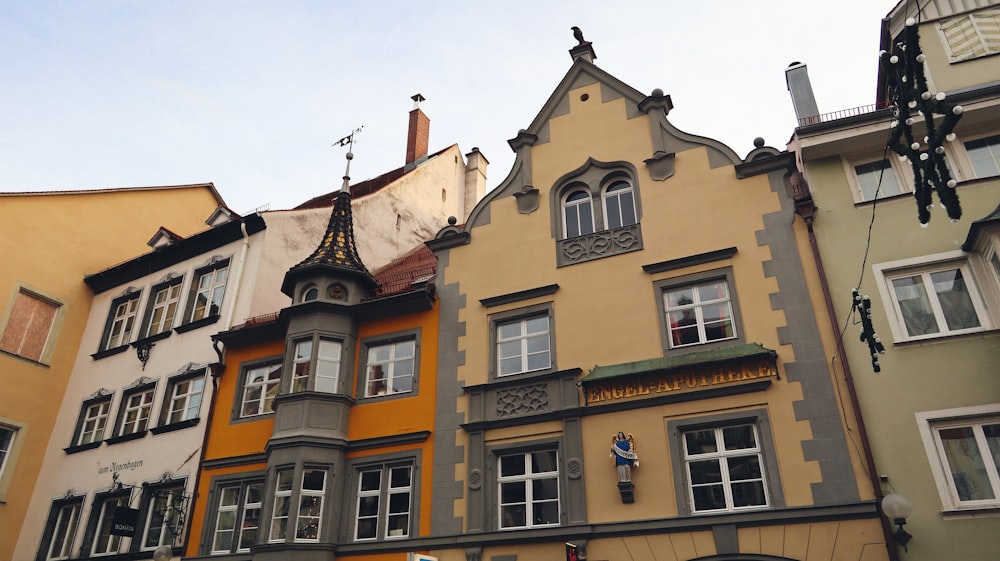 a row of multicolored buildings with a clock tower