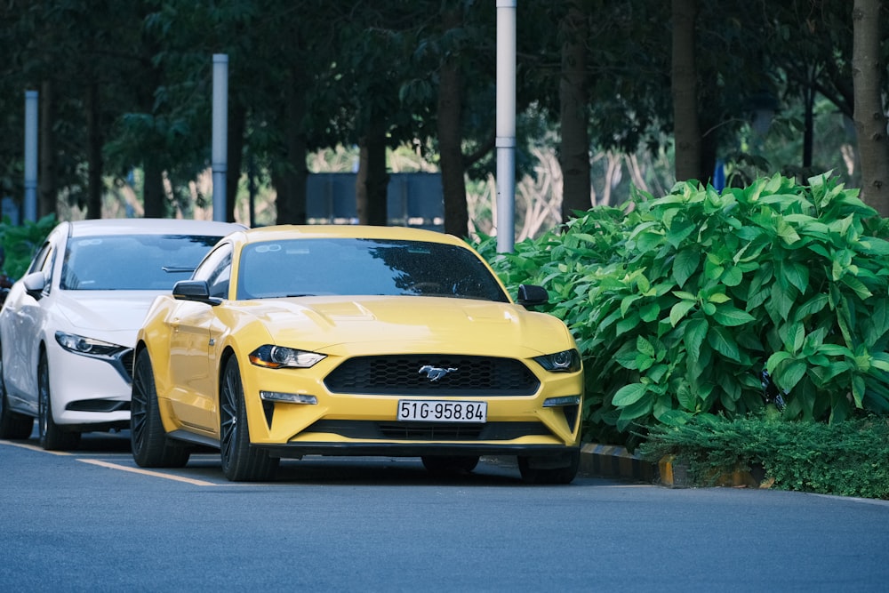 two yellow and white cars parked next to each other