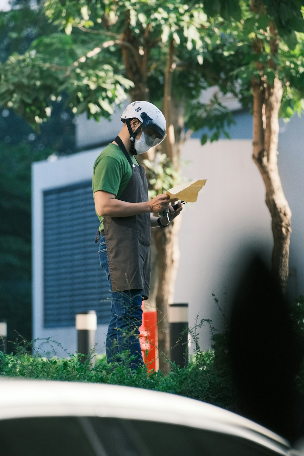 a man wearing a helmet and holding a piece of paper