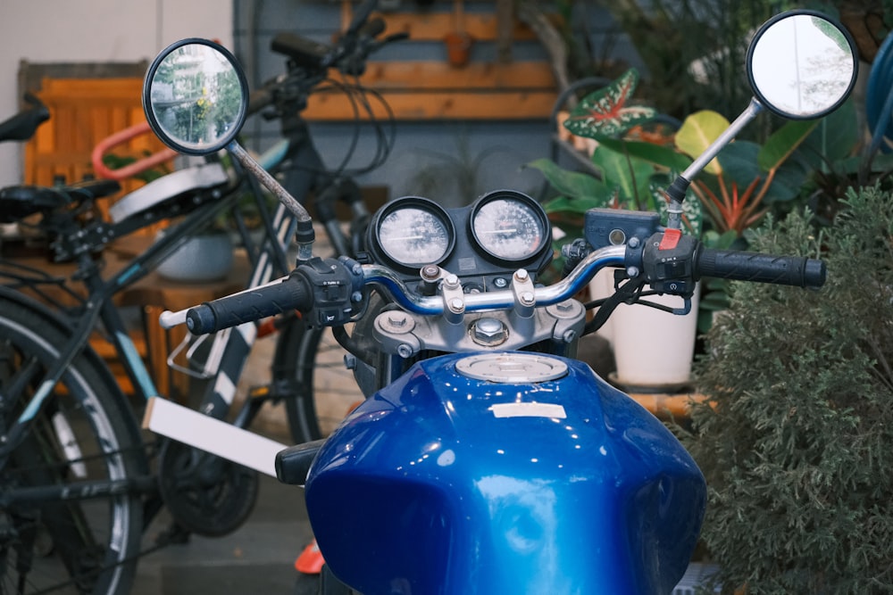 a blue motorcycle parked next to a bunch of bikes