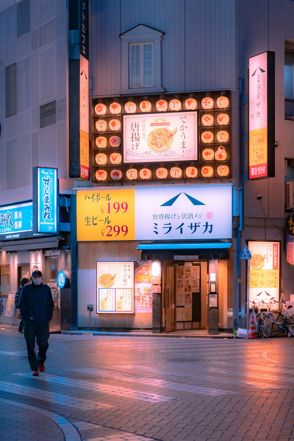 a man walking down a street at night