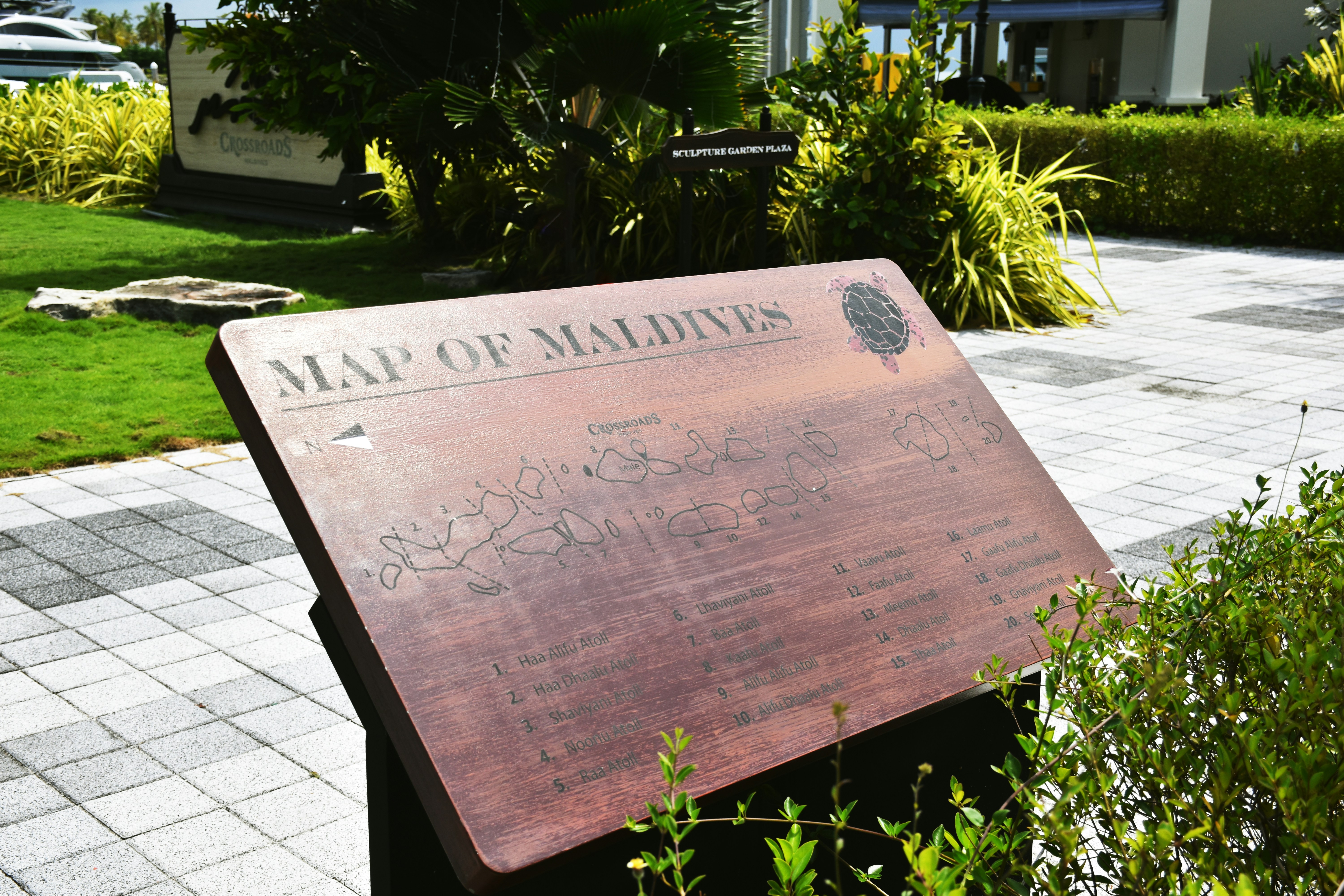 a wooden sign sitting on the side of a road