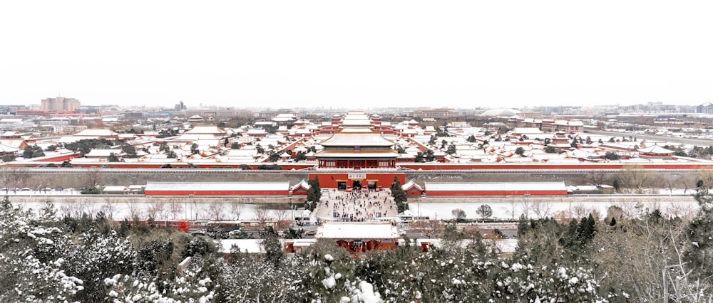 an aerial view of a large building in the snow