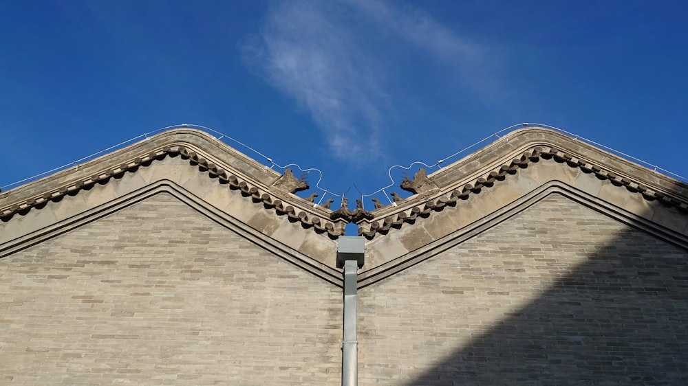 a brick building with a bird on top of it