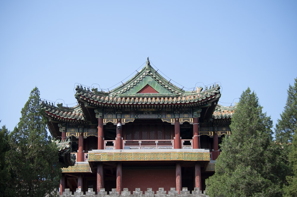 a tall building with a tall tower next to trees