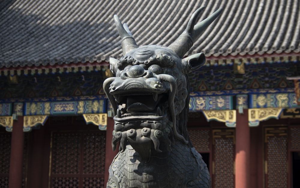 a statue of a dragon in front of a building