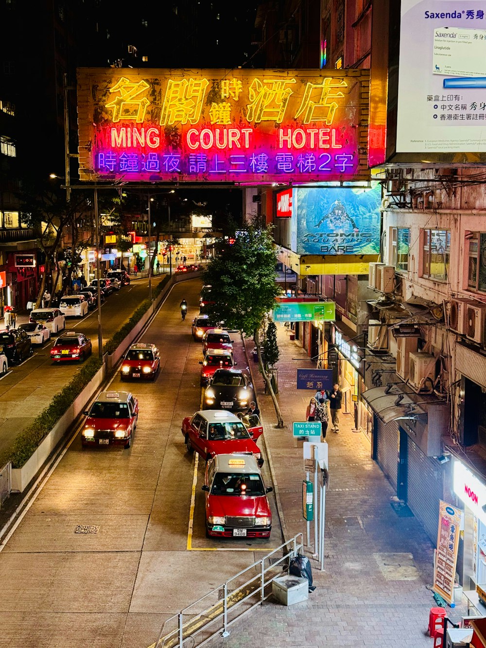 a street filled with lots of traffic next to tall buildings