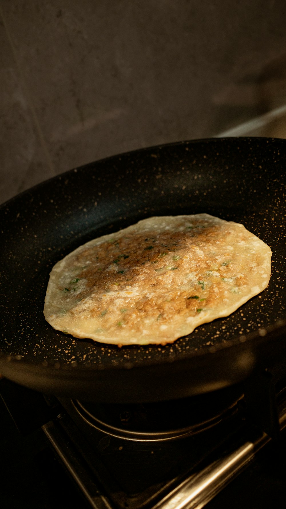 a skillet with some food cooking on top of it