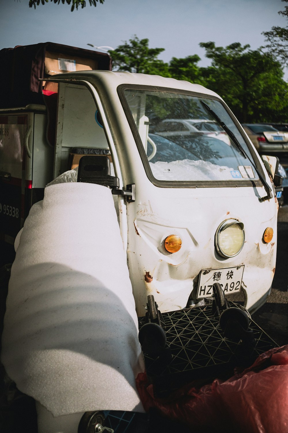 a white truck parked next to a pile of garbage