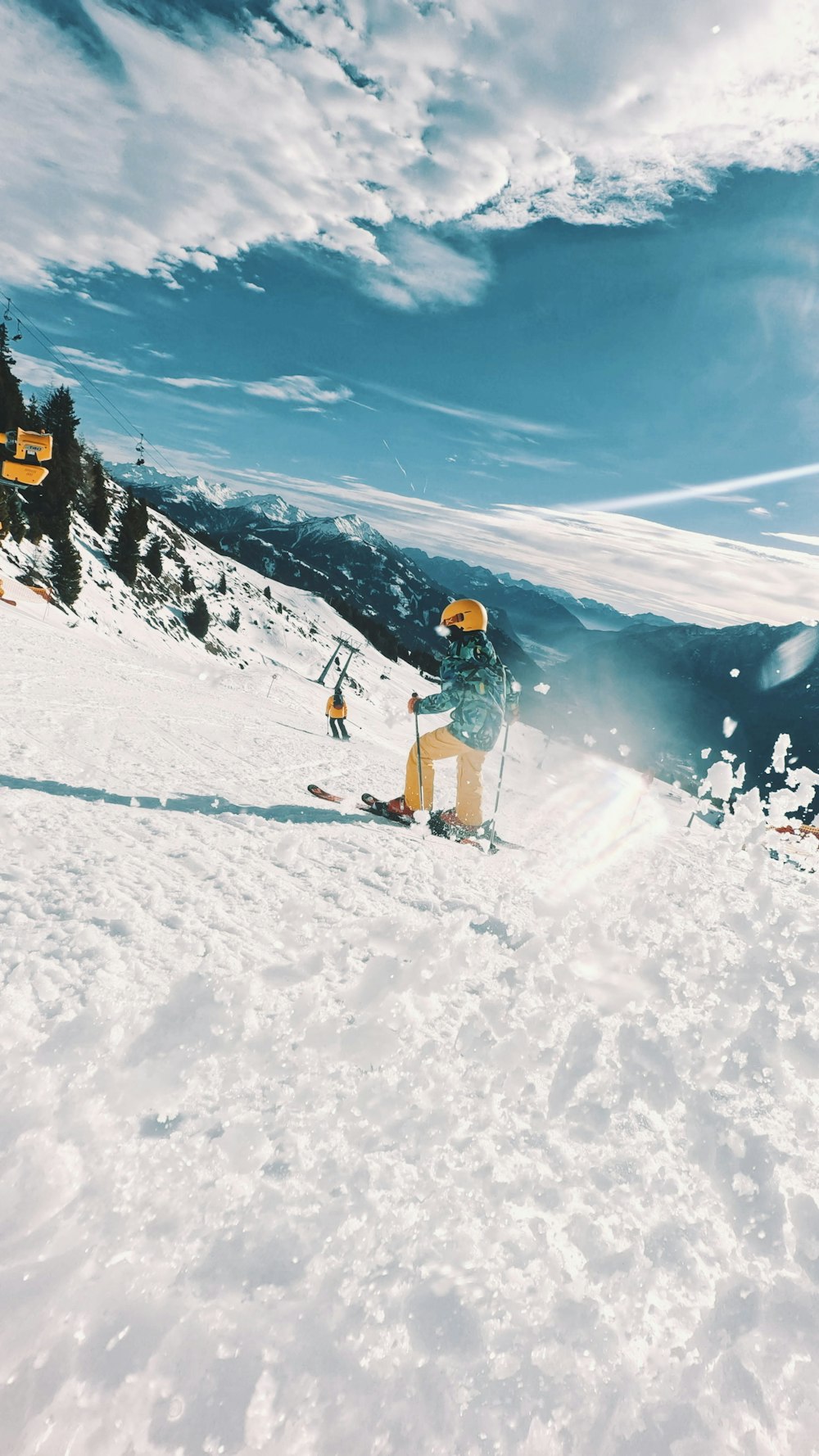 a man riding skis down a snow covered slope