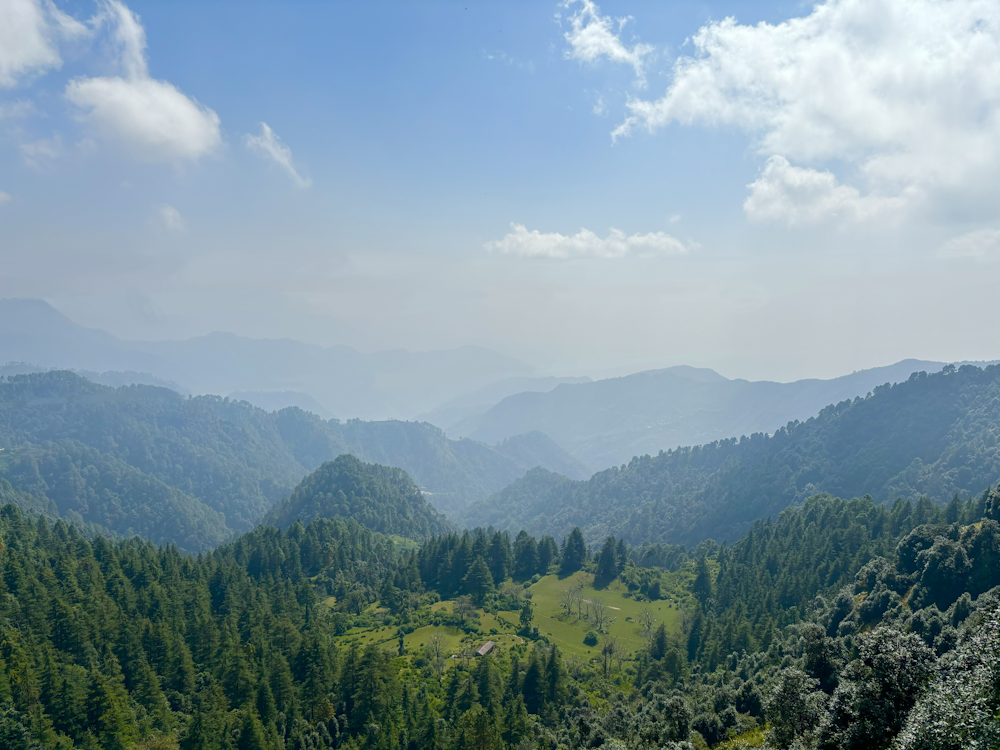 a view of a valley with mountains in the background