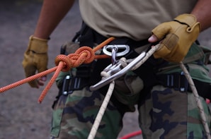 a man holding a rope and a pair of scissors