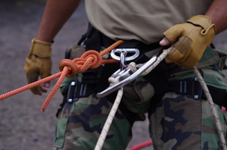 a man holding a rope and a pair of scissors