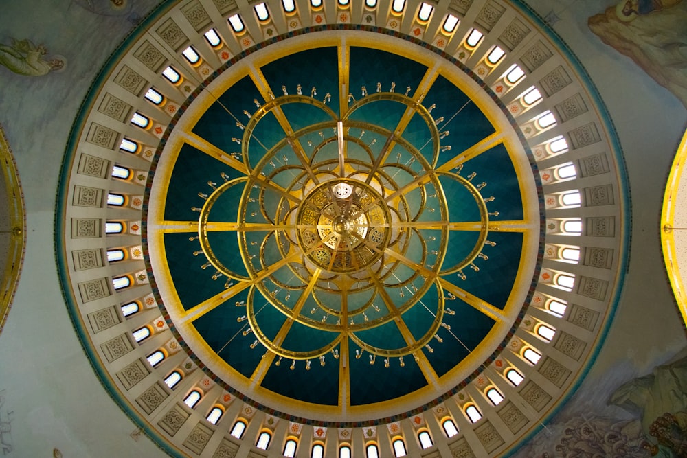 the ceiling of a building with a clock in the center