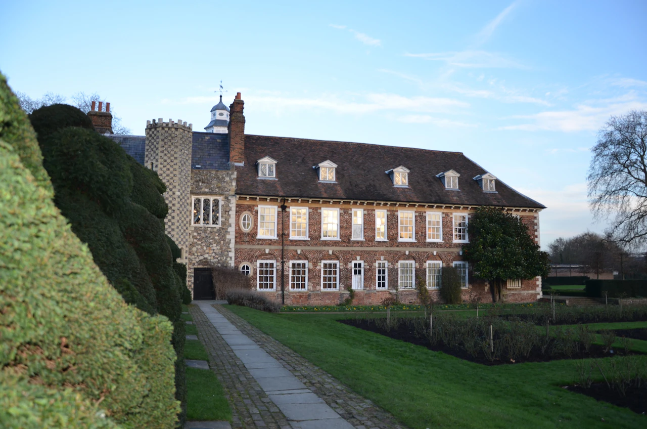 A large English country house with a clock tower