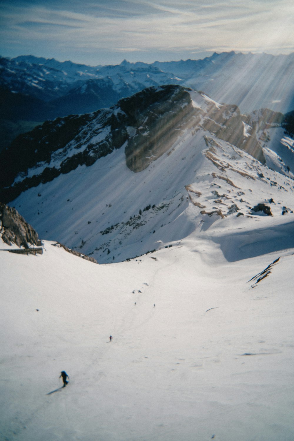 a man riding skis down a snow covered slope