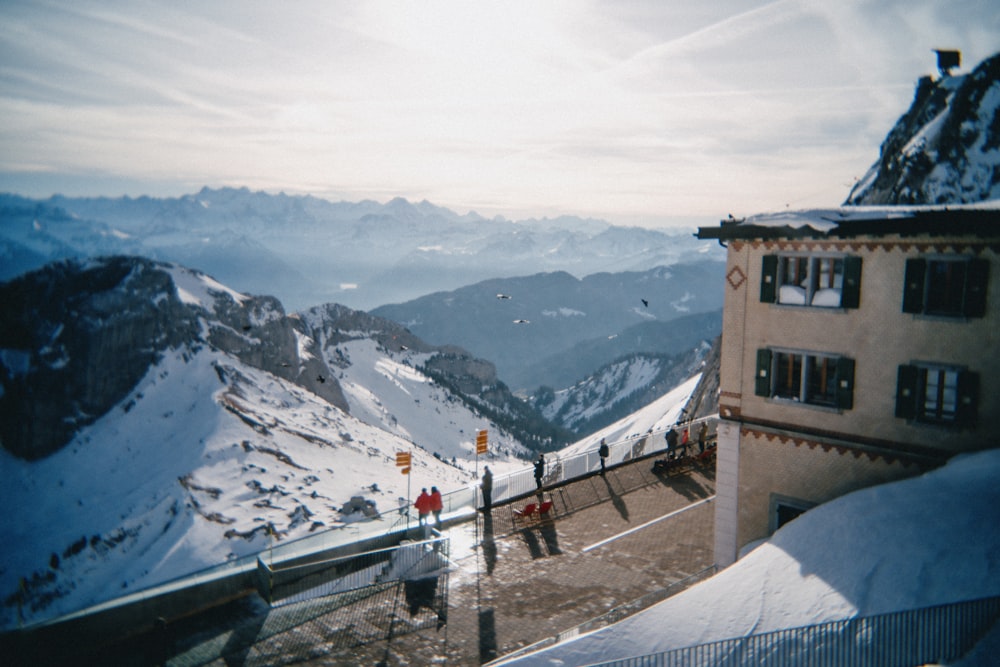 a group of people standing on top of a snow covered slope