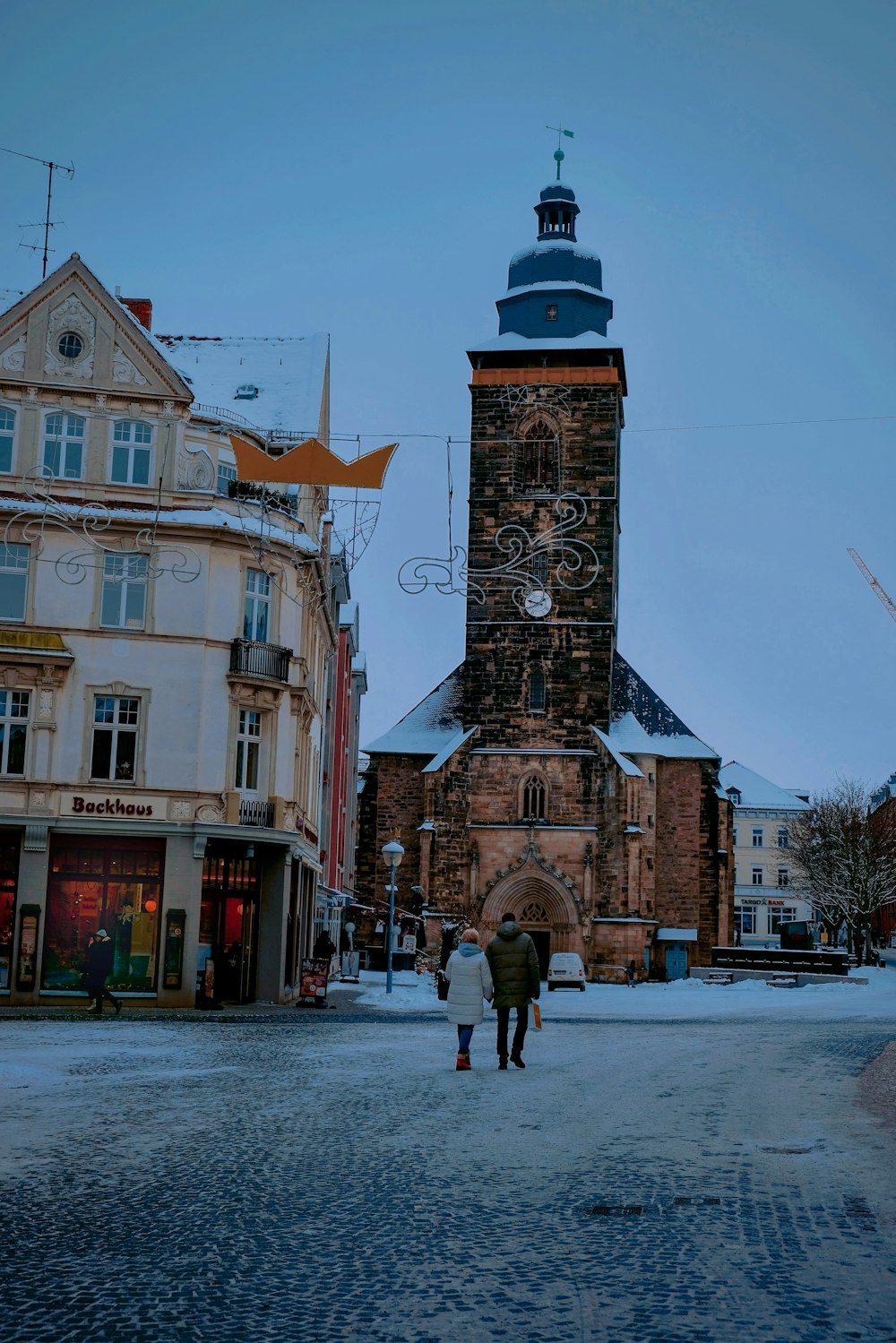 a couple of people that are walking in the snow