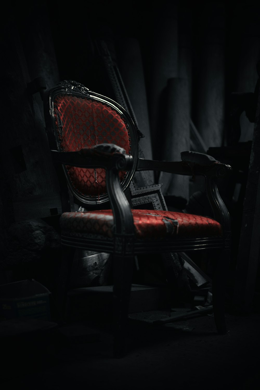 a red chair sitting in a dark room