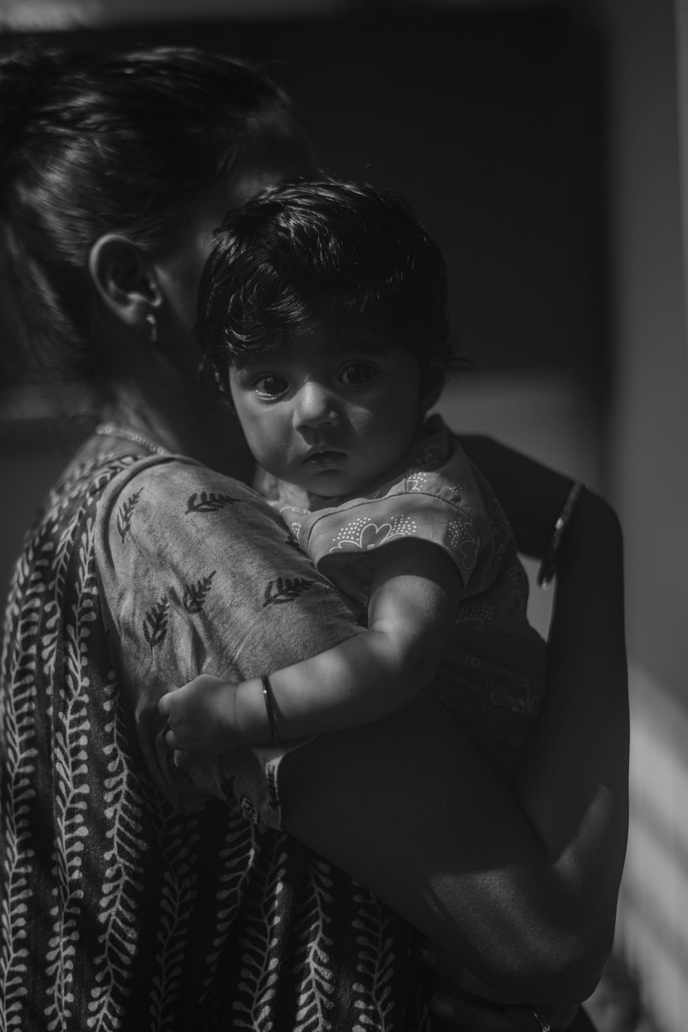 a woman holding a child in her arms