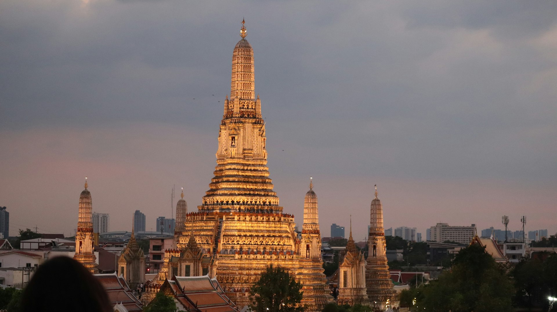 Wat Arun's spire glowing at golden hour, Bangkok, Thailand