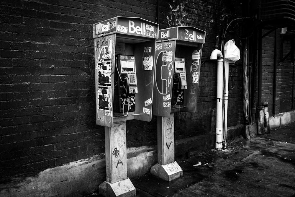 a black and white photo of a couple of parking meters