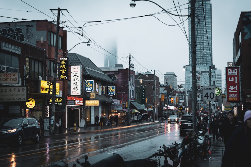 a city street filled with lots of traffic next to tall buildings