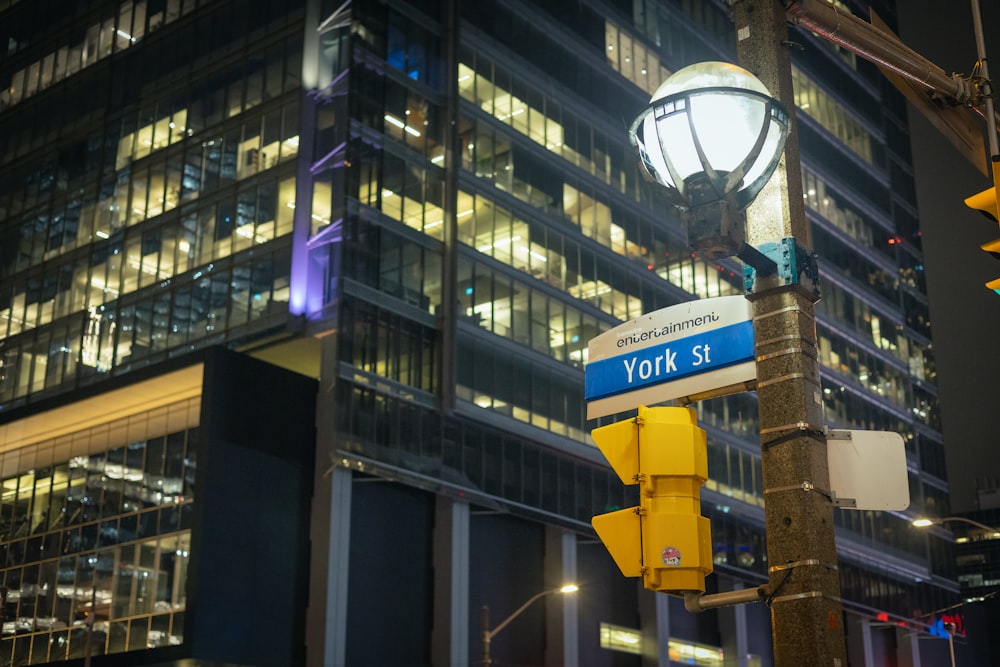 a street light with a street sign in front of a building