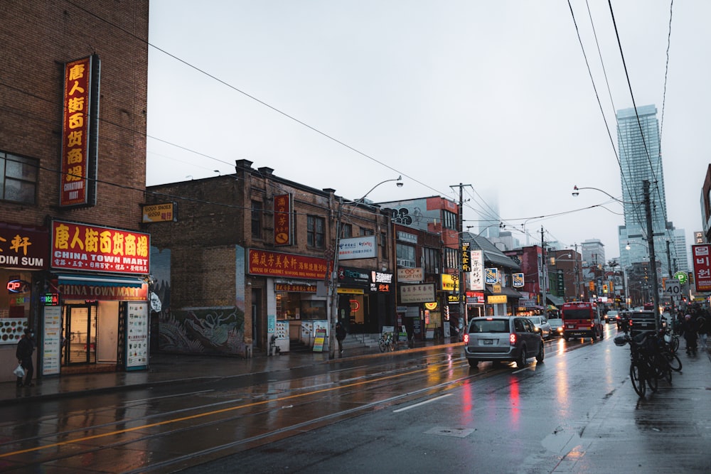 a city street filled with lots of traffic next to tall buildings