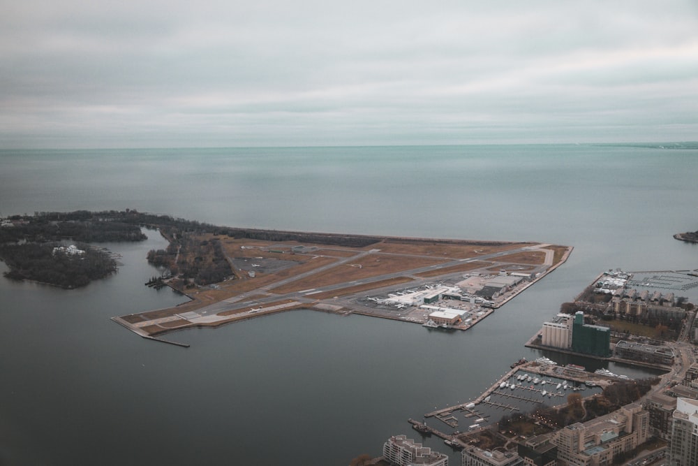 an aerial view of a runway and a body of water