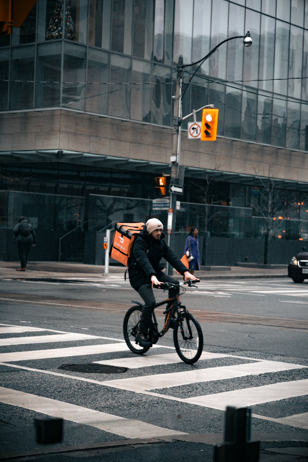 a man riding a bike across a street