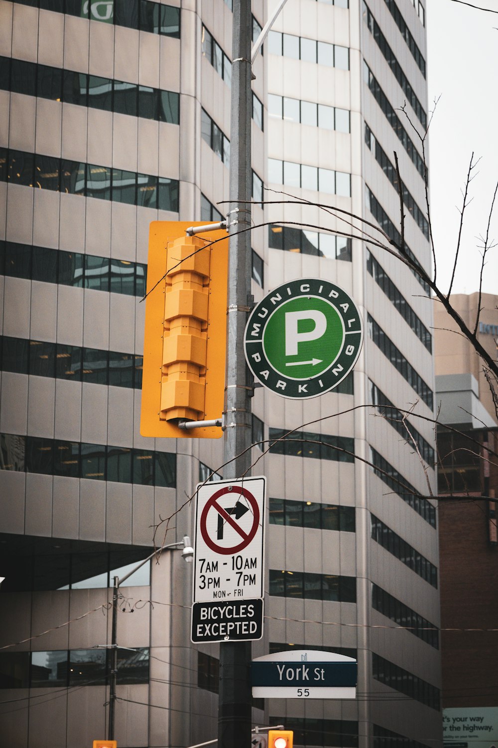 a traffic light hanging from the side of a pole