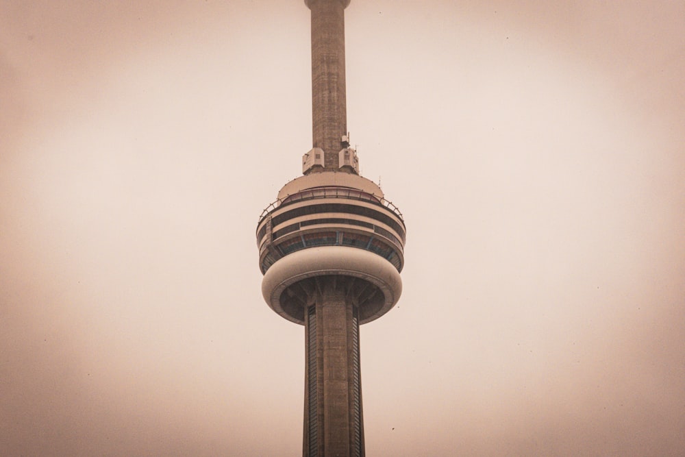 a very tall tower with a clock on it's side