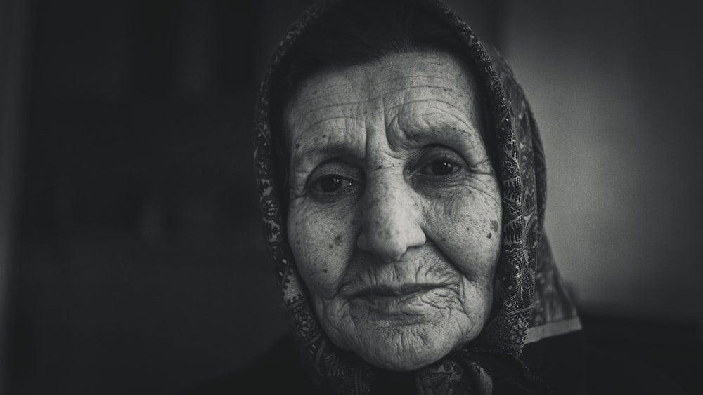 a black and white photo of an old woman