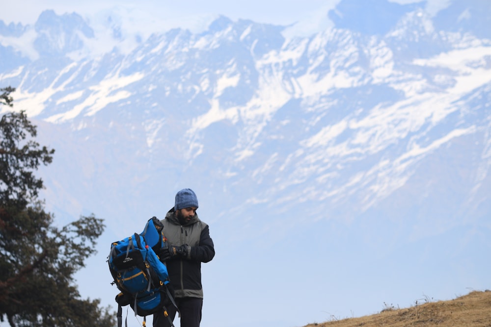 a man with a backpack walking up a hill