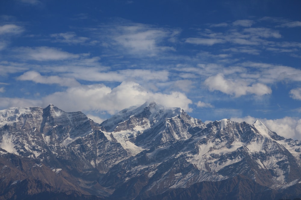 a view of a mountain range with clouds in the sky