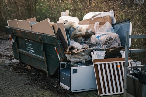 a pile of garbage sitting next to a pile of trash