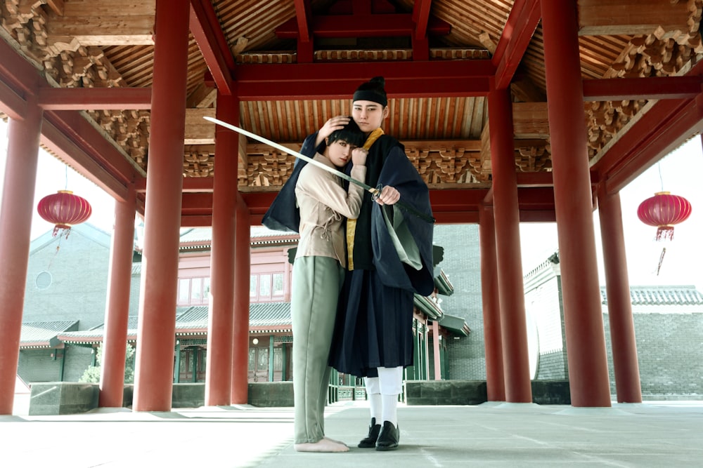 a man and a woman standing under a building