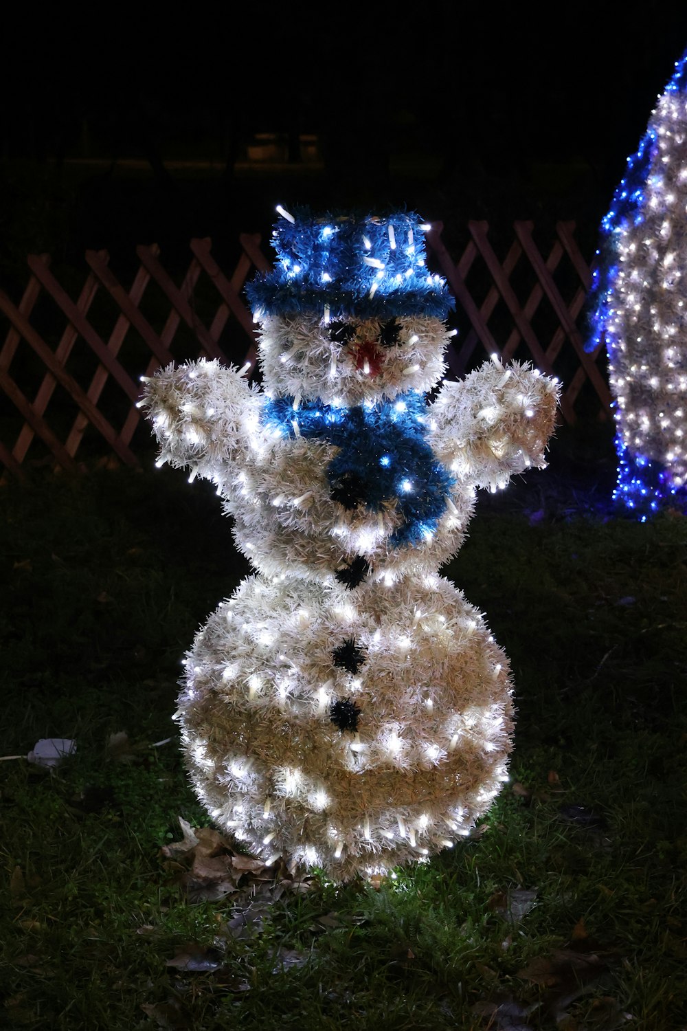 a snowman made out of hay and christmas lights