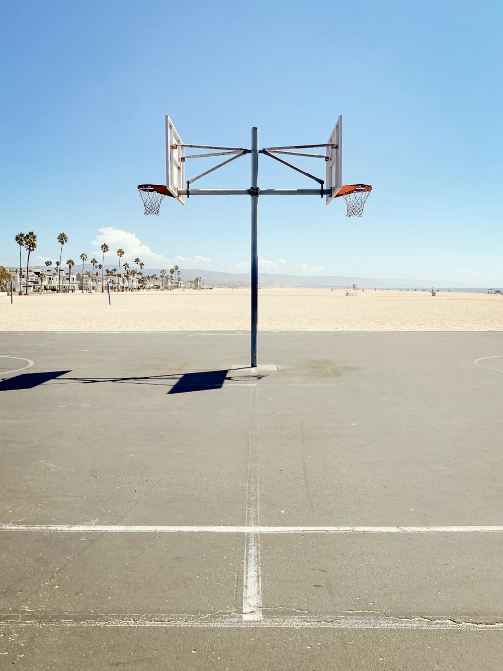 an empty basketball court with a basketball hoop