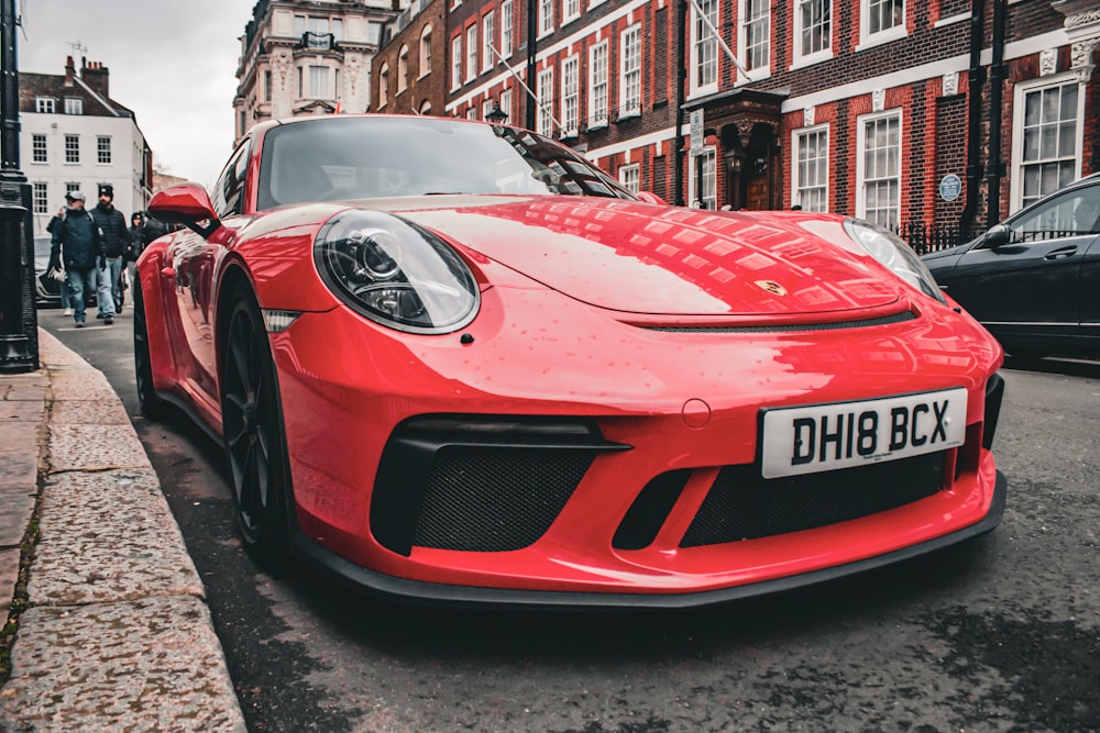 a red sports car parked on the side of the road