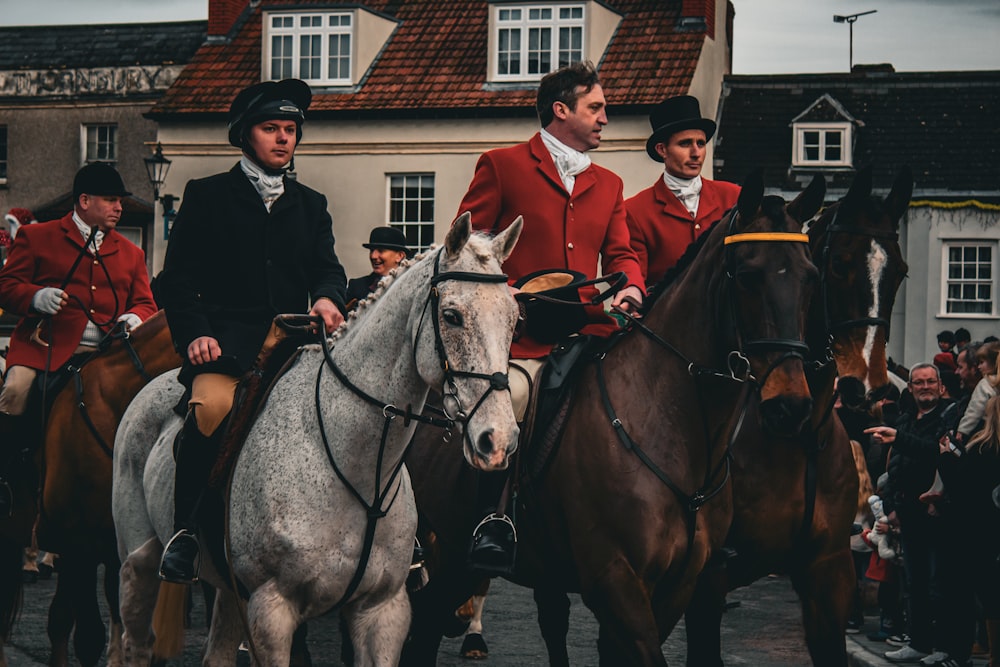 a group of men riding on the backs of horses